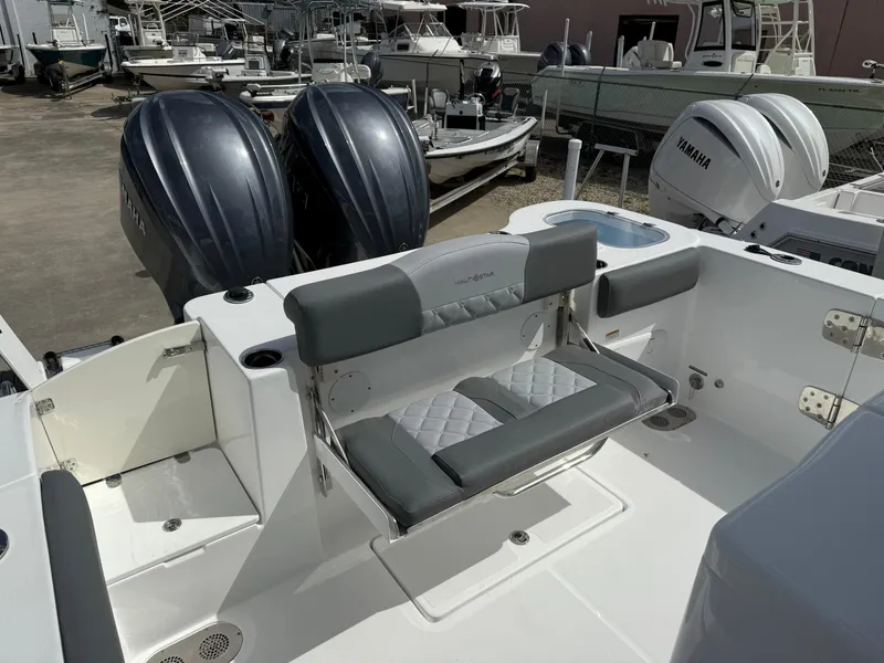 Slide: The Image of 2025 NauticStar 292 Legacy boat with dual engines and cushioned seating. - 9