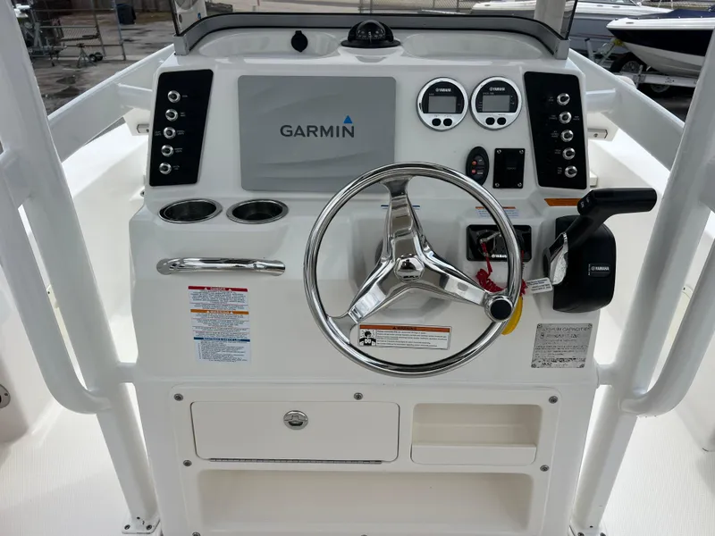 Slide: The Image of 2018 Robalo 226 Cayman boat dashboard with Garmin navigation system and steering wheel. - 10