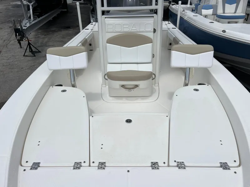 Slide: The Image of 2018 Robalo 226 Cayman boat interior with seating and storage compartments. - 12