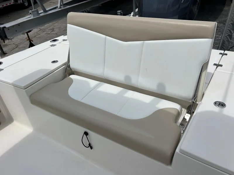 Slide: The Image of 2018 Robalo 226 Cayman boat seat, beige and white upholstery, outdoor setting. - 15