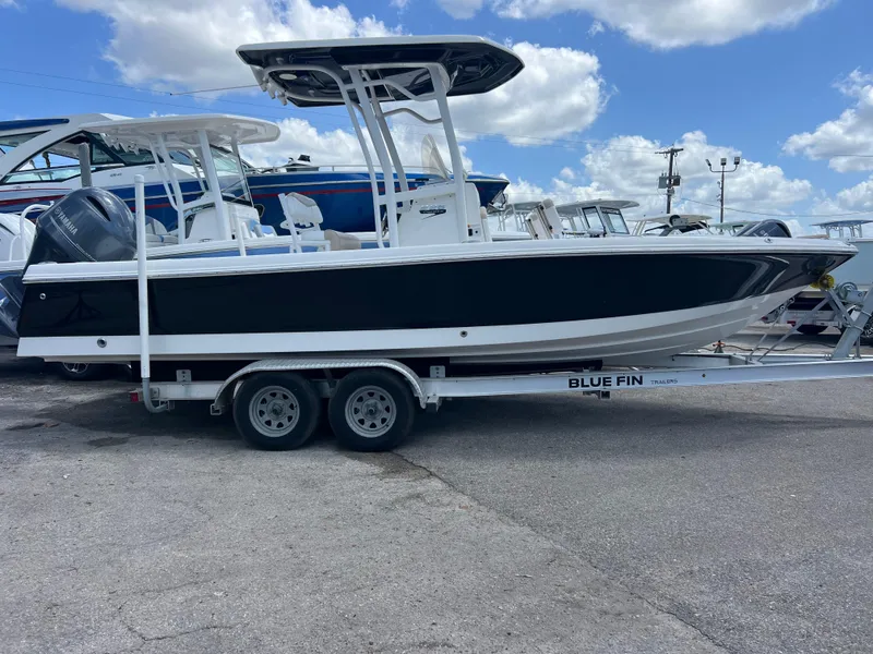 Slide: The Image of 2018 Robalo 226 Cayman boat on trailer under blue sky. - 2