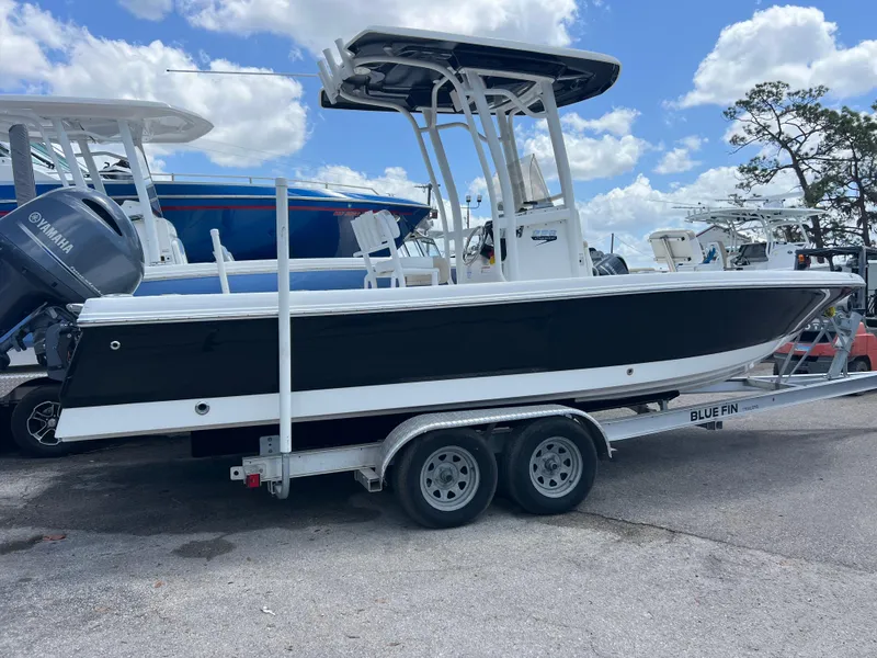 Slide: The Image of 2018 Robalo 226 Cayman boat on trailer, black hull, Yamaha engine, parked outdoors. - 3