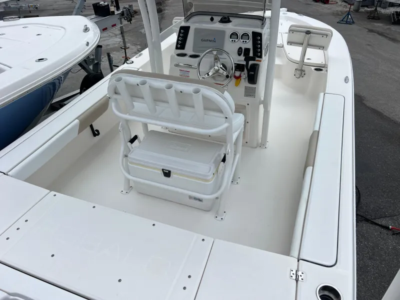 Slide: The Image of 2018 Robalo 226 Cayman boat interior with helm, seating, and storage. - 7