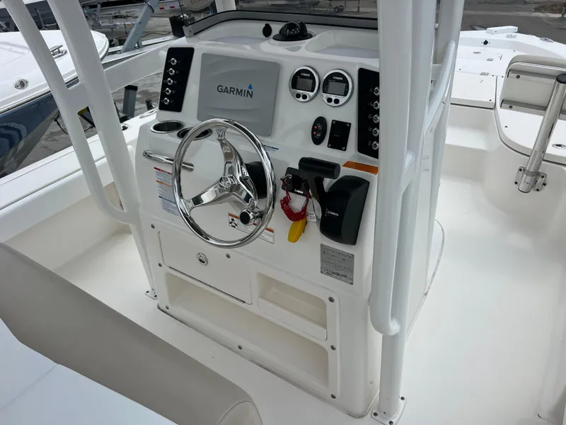 Slide: The Image of 2018 Robalo 226 Cayman boat console with Garmin navigation system and steering wheel. - 9