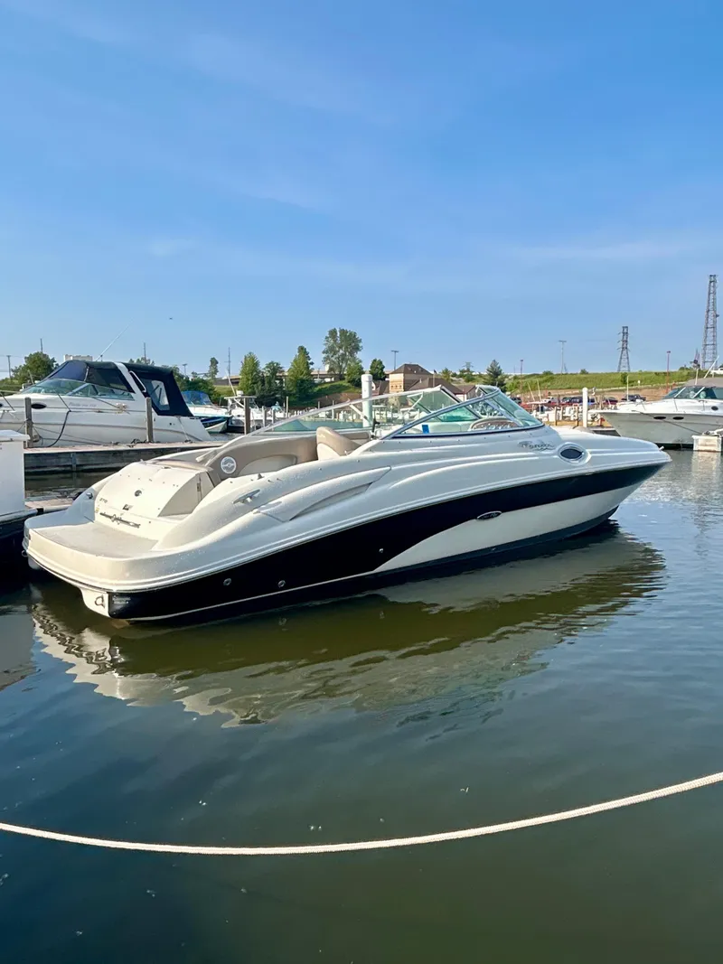 Slide: The Image of 2002 Sea Ray 270 Sundeck boat docked in a marina under clear blue skies. - 0