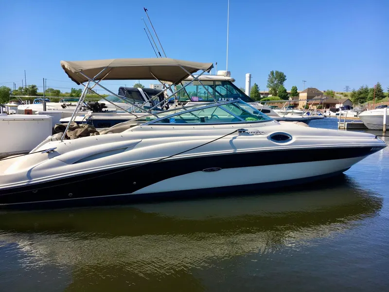 Slide: The Image of 2002 Sea Ray 270 Sundeck boat docked at marina under clear blue sky. - 1