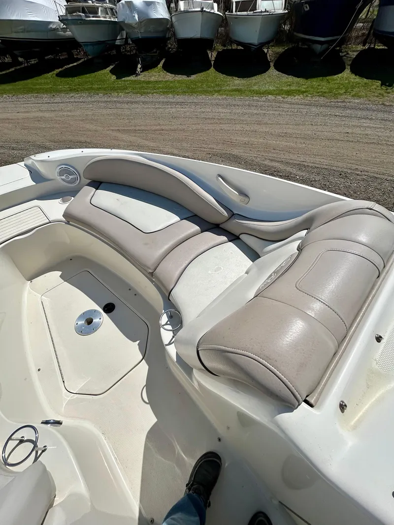 Slide: The Image of 2002 Sea Ray 270 Sundeck boat interior with beige seating and deck view. - 11