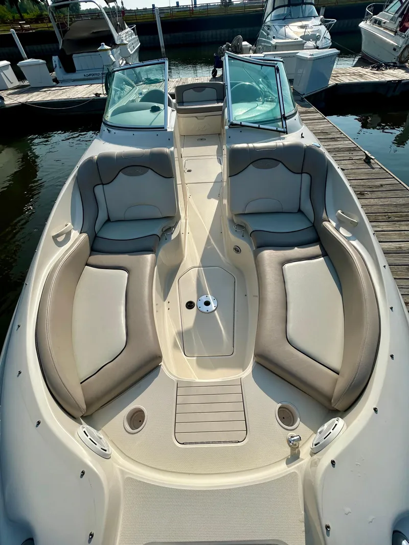 Slide: The Image of 2002 Sea Ray 270 Sundeck boat with spacious seating, docked at a marina. - 13