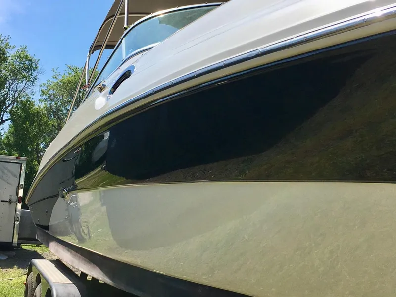 Slide: The Image of 2002 Sea Ray 270 Sundeck boat on trailer, side view with trees in background. - 18