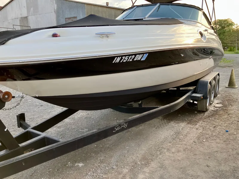 Slide: The Image of 2002 Sea Ray 270 Sundeck boat on trailer, parked outdoors. - 2