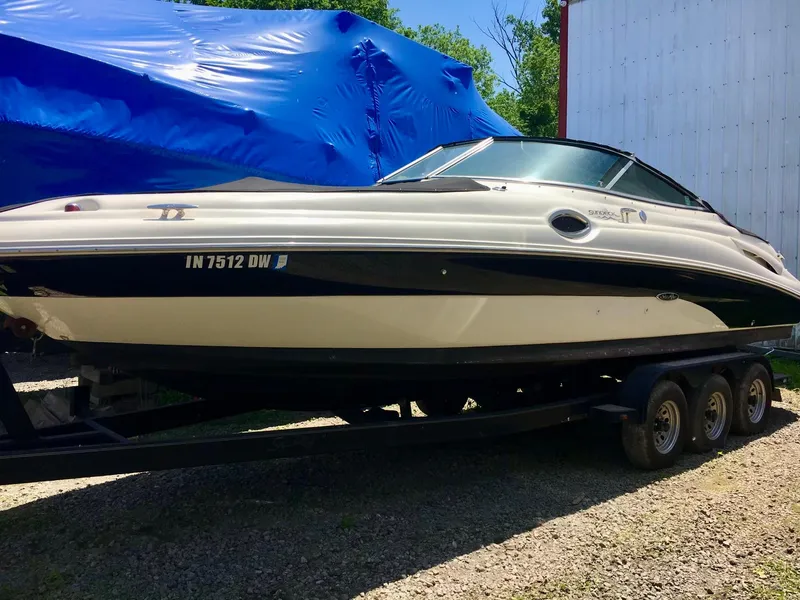 Slide: The Image of 2002 Sea Ray 270 Sundeck boat on trailer, parked outdoors. - 24