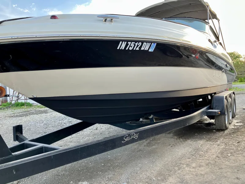 Slide: The Image of 2002 Sea Ray 270 Sundeck boat on trailer, side view, outdoors. - 26