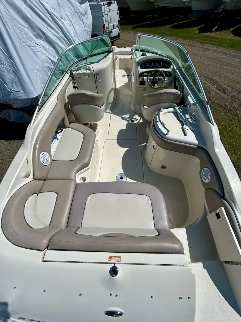 Slide: The Image of 2002 Sea Ray 270 Sundeck interior with seating and steering console. - 7