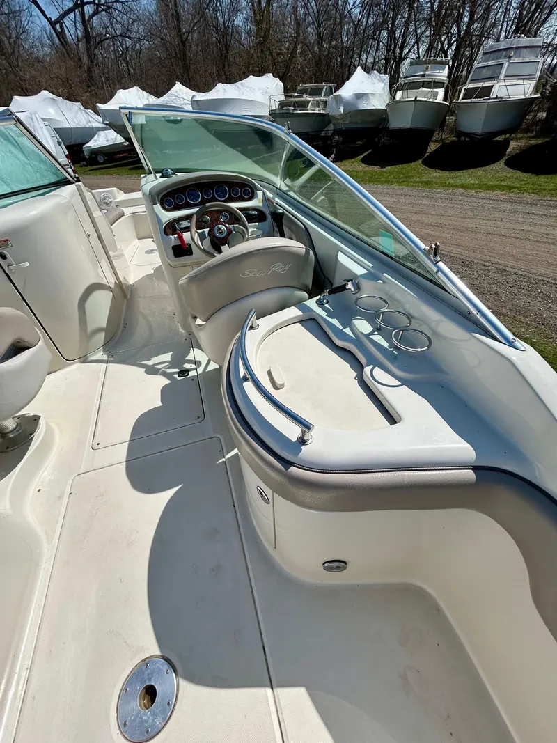 Slide: The Image of 2002 Sea Ray 270 Sundeck interior with steering wheel and seating area. - 9