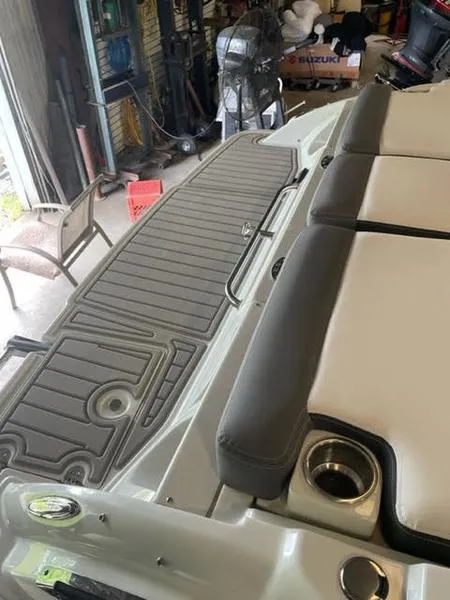 Slide: The Image of 2023 Crownline 200 SS boat interior with cushioned seating and non-slip flooring. - 3