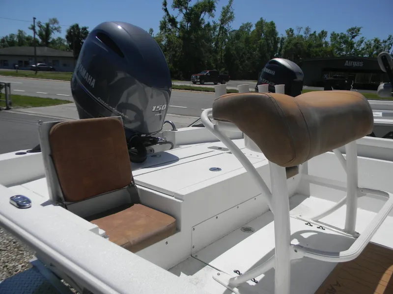 Slide: The Image of Avid 21 Mag 2023 boat with Yamaha engine, featuring cushioned seating and white deck. - 10