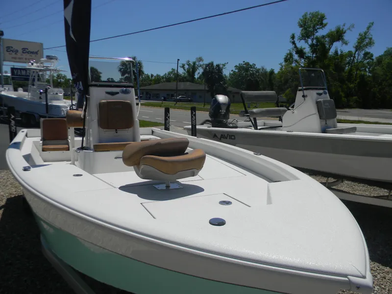 Slide: The Image of 2023 Avid 21 Mag boat displayed outdoors, featuring sleek design and modern seating. - 13