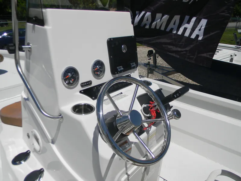 Slide: The Image of Steering console of 2023 Avid 21 Mag boat with gauges and controls. - 16