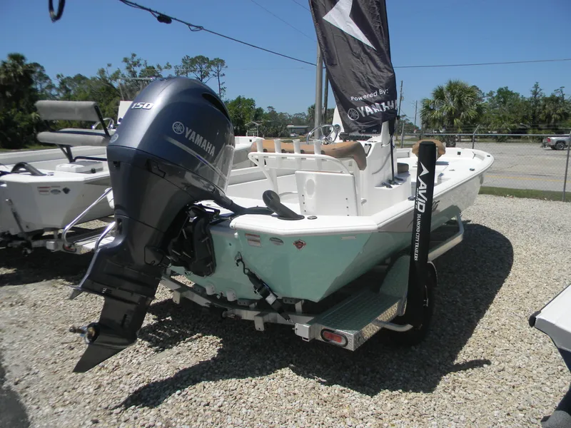 Slide: The Image of 2023 Avid 21 Mag boat with Yamaha outboard motor, displayed outdoors on gravel. - 9