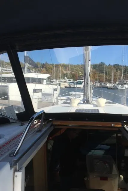 Slide: The Image of View from inside a 1999 Hunter 380 sailboat docked at a marina. - 10