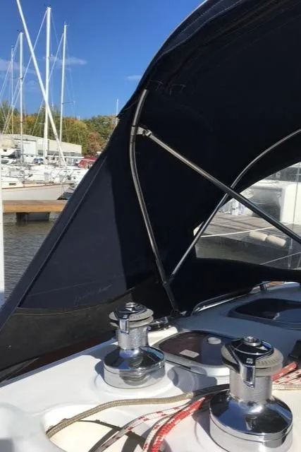 Slide: The Image of Sailboat deck with winches and canopy, Hunter 380, 1999 model, marina background. - 11