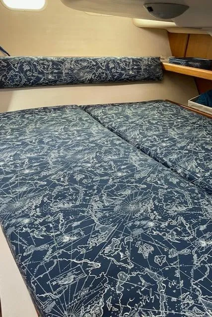 Slide: The Image of Interior of a 1999 Hunter 380 sailboat with nautical-themed bedding. - 20