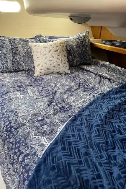 Slide: The Image of Cozy cabin bed with patterned bedding in a 1999 Hunter 380 sailboat. - 21
