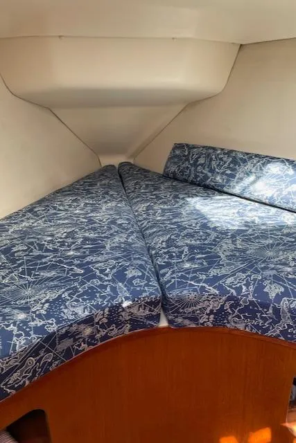 Slide: The Image of 1999 Hunter 380 sailboat interior with blue patterned cushions in the cabin. - 29
