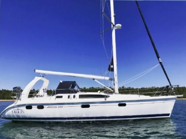 Slide: The Image of 1999 Hunter 380 sailboat on calm water under clear blue sky. - 3