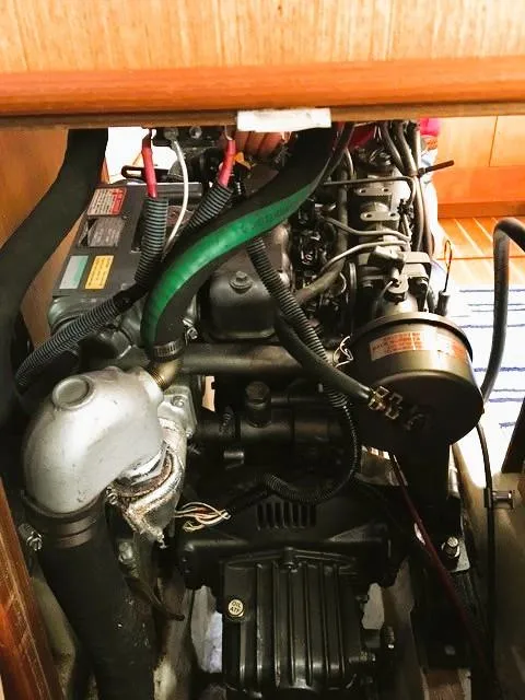 Slide: The Image of Engine compartment of a 1999 Hunter 380 sailboat, showcasing detailed mechanical components. - 32