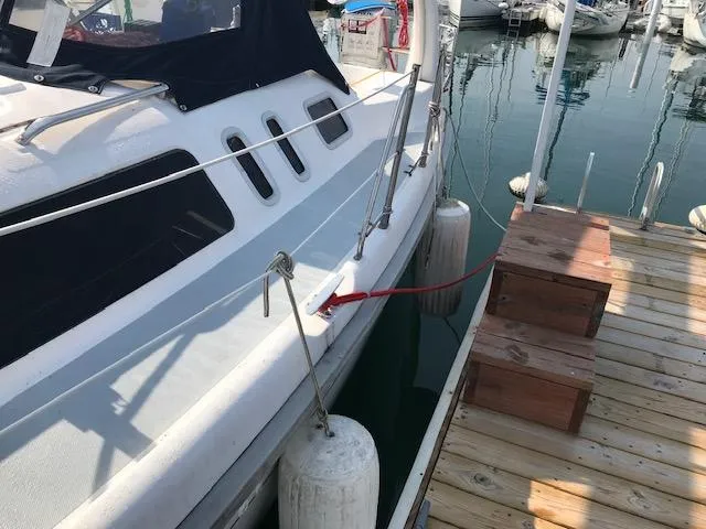 Slide: The Image of Hunter 380 sailboat docked, 1999 model, with fenders and wooden dock steps. - 34