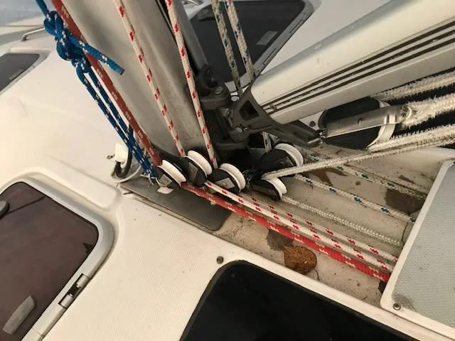 Slide: The Image of Sailboat rigging on a 1999 Hunter 380, featuring ropes and pulleys. - 36