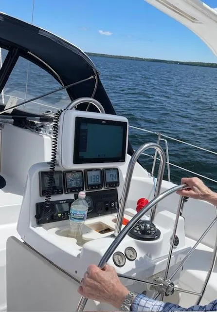 Slide: The Image of Sailboat helm with navigation equipment, Hunter 380, 1999 model, on open water. - 39
