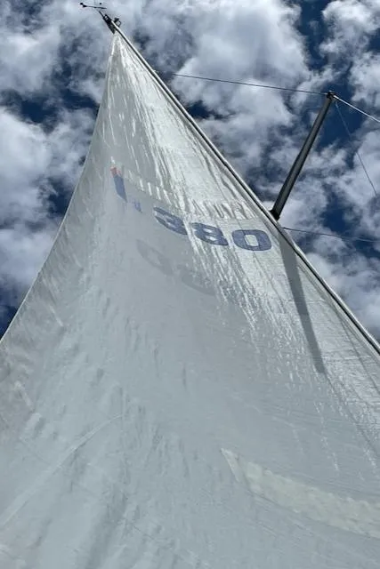 Slide: The Image of Sail of a 1999 Hunter 380 yacht against a cloudy sky. - 42