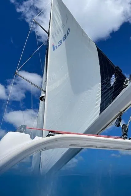 Slide: The Image of Sailing yacht Hunter 380, 1999 model, with white sails against a blue sky. - 43
