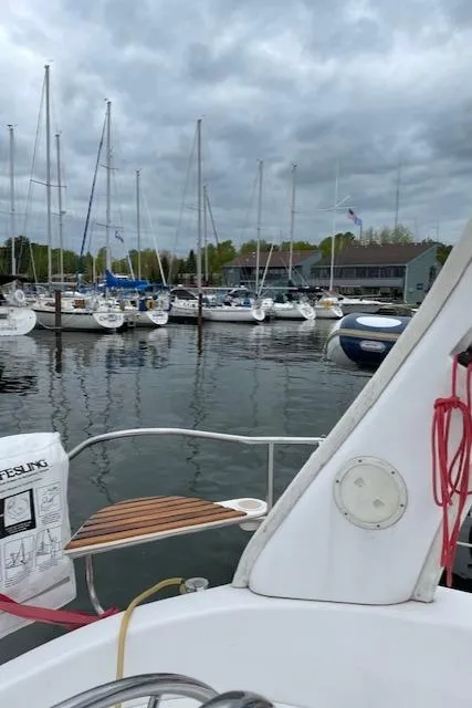 Slide: The Image of 1999 Hunter 380 sailboat docked at marina with cloudy sky. - 46