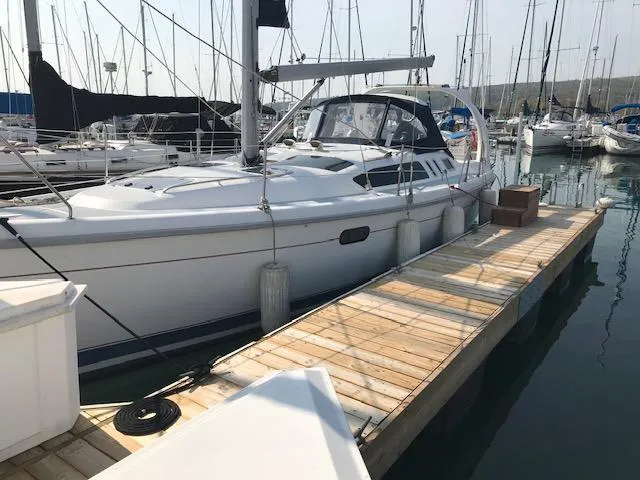 Slide: The Image of Hunter 380 sailboat from 1999 docked at a marina with other boats. - 5