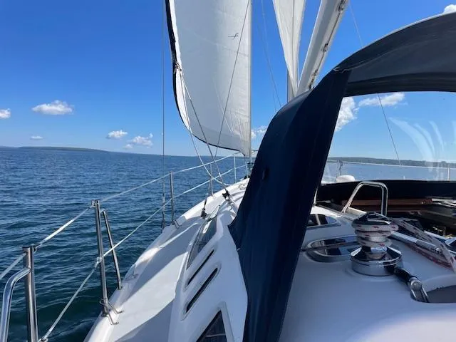 Slide: The Image of Sailing on a 1999 Hunter 380 yacht with white sails and blue sky. - 7