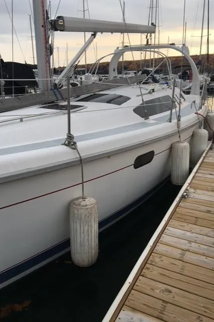 Slide: The Image of 1999 Hunter 380 sailboat docked at marina with fenders. - 8