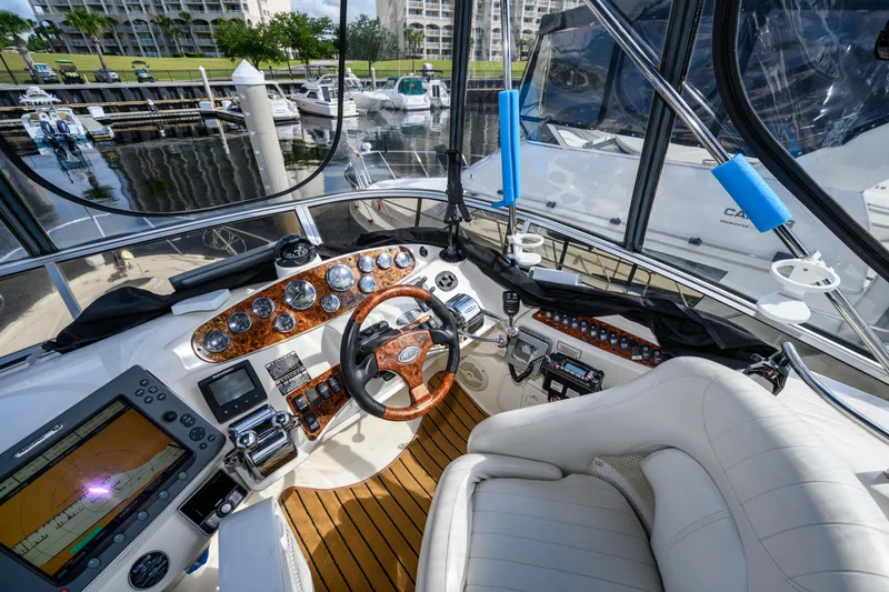 Slide: The Image of 2008 Meridian 341 Sedan yacht cockpit with luxurious controls and marina view. - 15