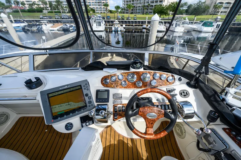 Slide: The Image of 2008 Meridian 341 Sedan yacht cockpit with navigation controls and marina view. - 16