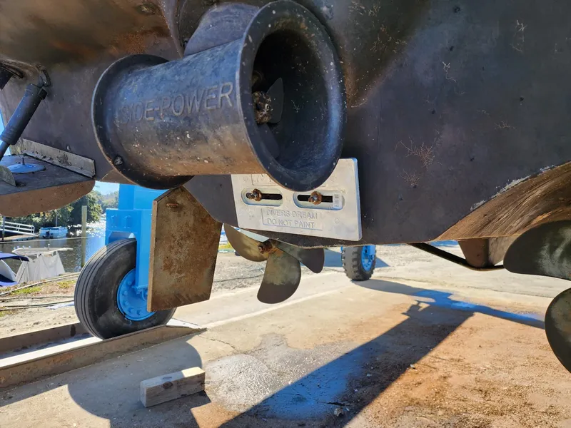 Slide: The Image of 2008 Meridian 341 Sedan boat underside with propeller and thruster, docked on a sunny day. - 44