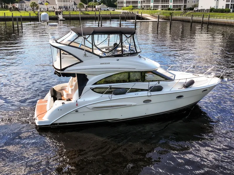 Slide: The Image of 2008 Meridian 341 Sedan yacht on calm water near a marina. - 5