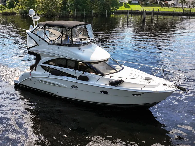 Slide: The Image of 2008 Meridian 341 Sedan yacht cruising on a calm river. - 6