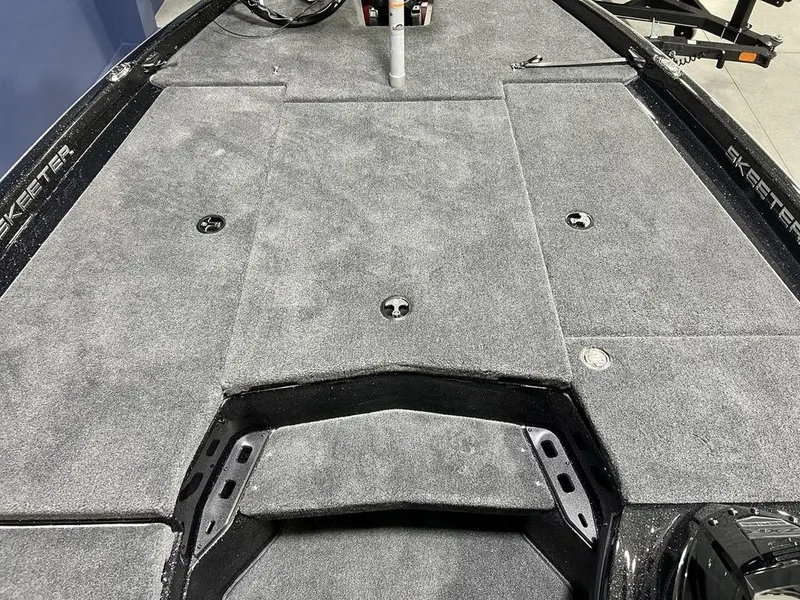 Slide: The Image of 2025 Skeeter ZXR20 boat deck with gray carpeting and storage compartments. - 11