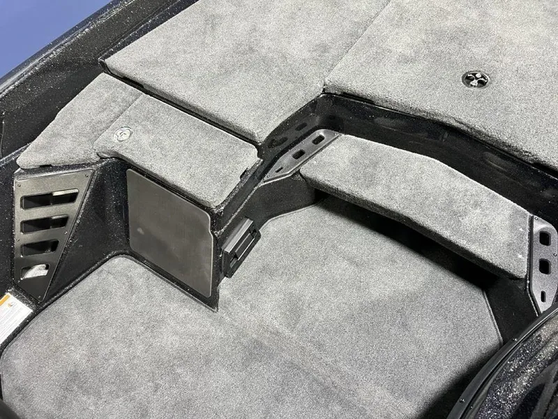 Slide: The Image of 2025 Skeeter ZXR20 boat interior with gray carpeted storage compartments. - 15