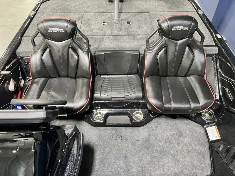 Slide: The Image of 2025 Skeeter ZXR20 boat interior with two black leather seats and red accents. - 17