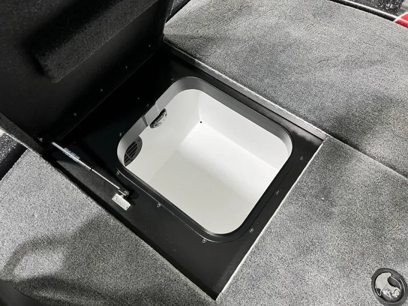 Slide: The Image of 2025 Skeeter ZXR20 boat storage compartment with open lid, showcasing interior space. - 22