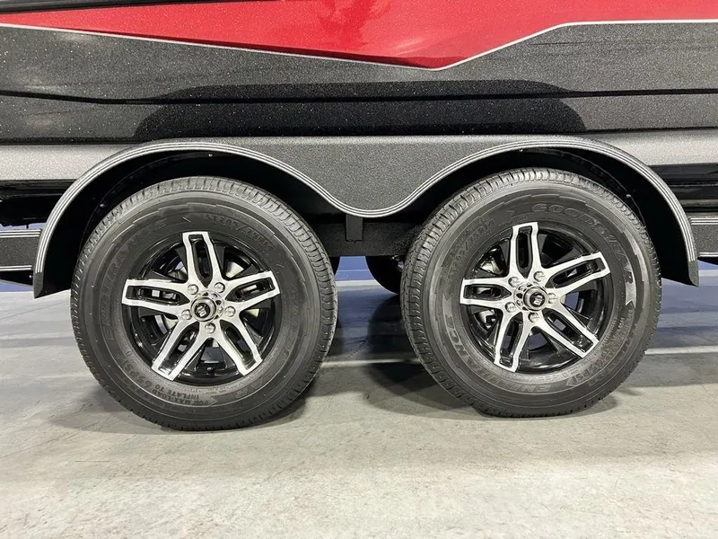 Slide: The Image of 2025 Skeeter ZXR20 boat trailer with dual black alloy wheels. - 3