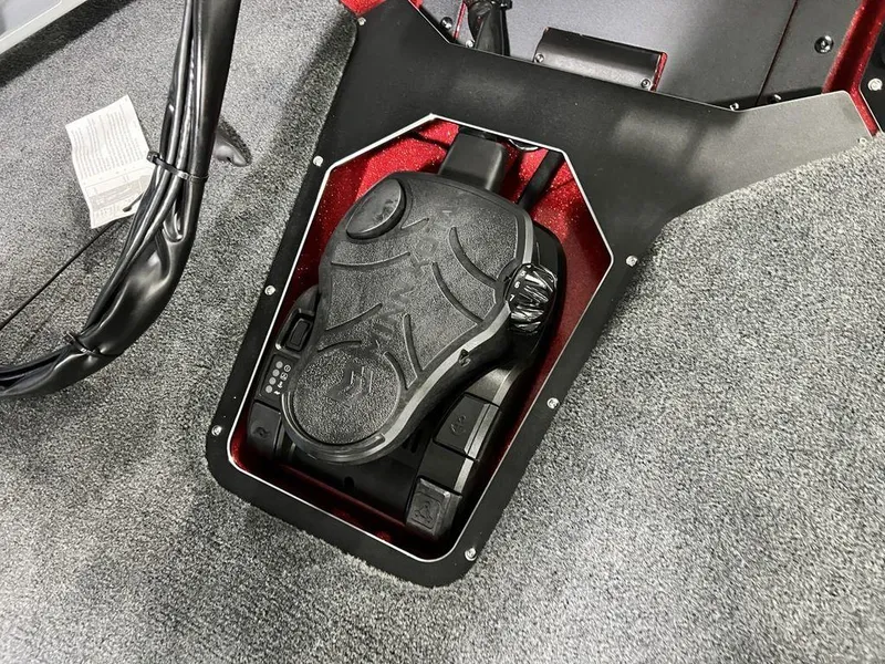 Slide: The Image of Foot pedal control in 2025 Skeeter ZXR20 boat, surrounded by gray carpet. - 6